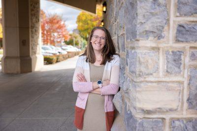 Corinne Guimont stands underneath the Torgersen Bridge on a fall sunny day.